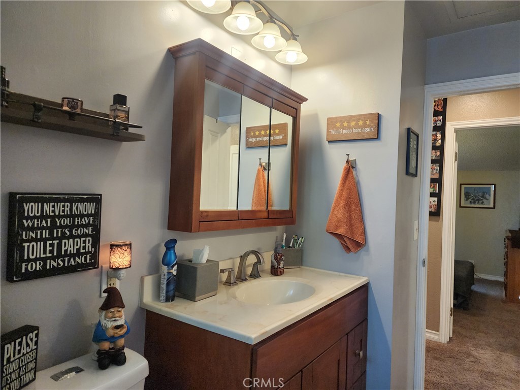 7450 Thunderbird Lane Stanton, CA 90680 - Photo 16 of 31 a bathroom with a sink vanity and a mirror