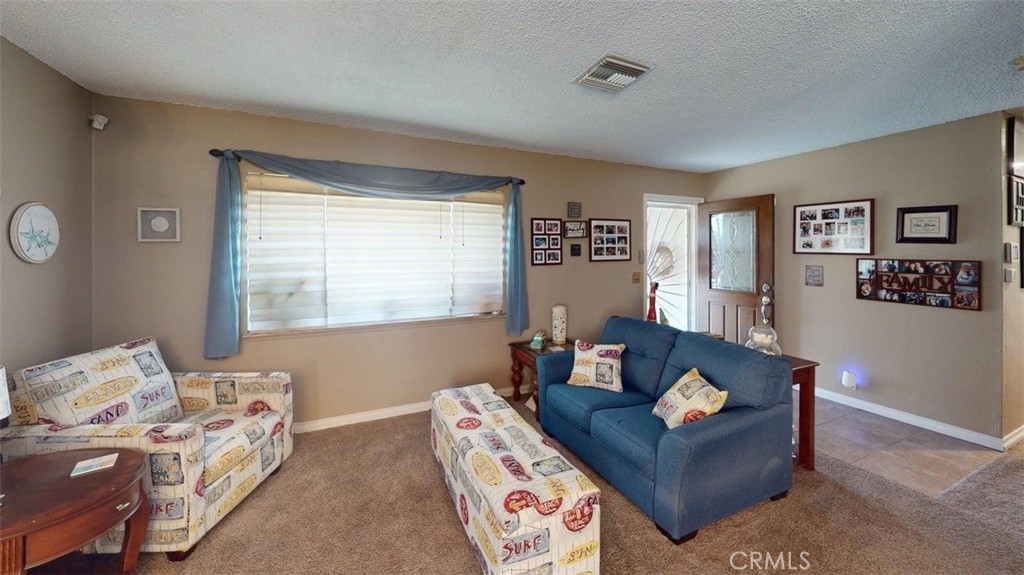 7450 Thunderbird Lane Stanton, CA 90680 - Photo 3 of 31 a living room with furniture and a window