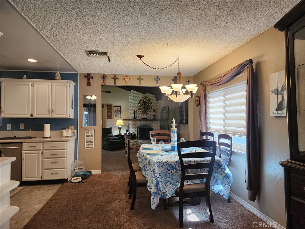 7450 Thunderbird Lane Stanton, CA 90680 - Photo 5 of 31 a view of a dining room with furniture and a chandelier