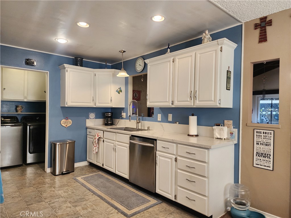 7450 Thunderbird Lane Stanton, CA 90680 - Photo 7 of 31 a kitchen with white cabinets and white appliances