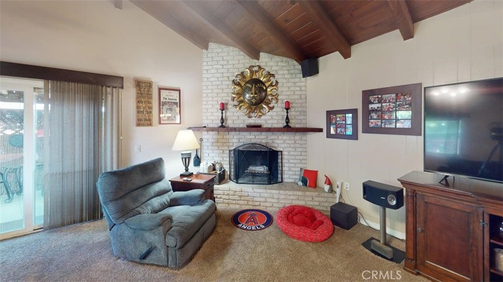 7450 Thunderbird Lane Stanton, CA 90680 - Photo 9 of 31 a living room with furniture kitchen view and a fireplace