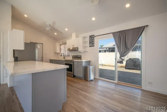 a kitchen with stainless steel appliances a refrigerator and a stove top oven