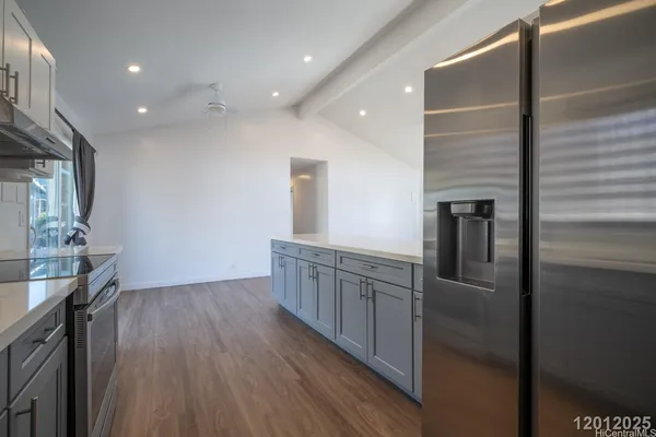a kitchen with stainless steel appliances granite countertop a refrigerator and a sink