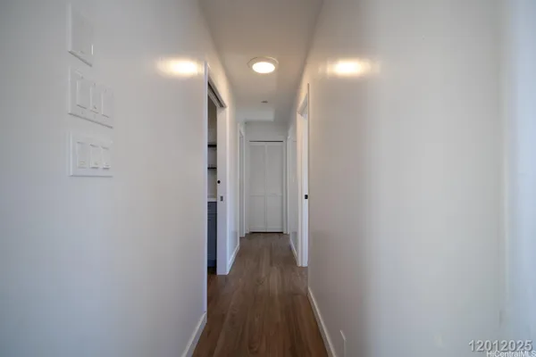 a view of a hallway with wooden floor