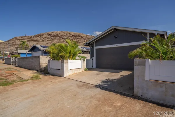 a backyard of a house with dishwasher and wooden fence