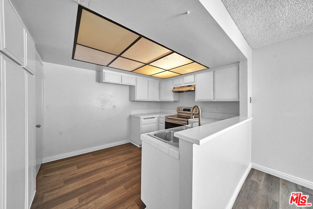 1333 Valley View Road, Unit 25 Glendale, CA 91202 - Photo 11 of 27 a kitchen with stainless steel appliances granite countertop a sink and a stove top oven