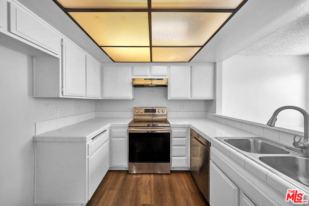1333 Valley View Road, Unit 25 Glendale, CA 91202 - Photo 13 of 27 a kitchen with granite countertop a sink stainless steel appliances and cabinets