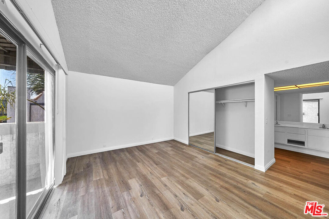 1333 Valley View Road, Unit 25 Glendale, CA 91202 - Photo 19 of 27 a view of an empty room with wooden floor and a window