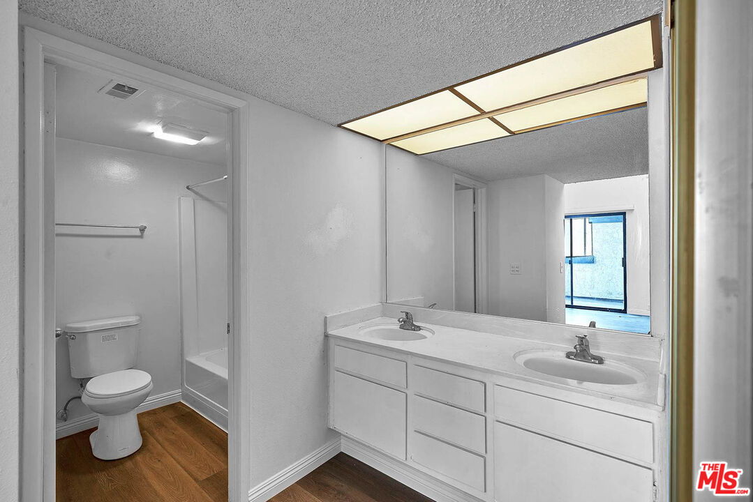 1333 Valley View Road, Unit 25 Glendale, CA 91202 - Photo 20 of 27 a bathroom with a double vanity sink toilet and a mirror