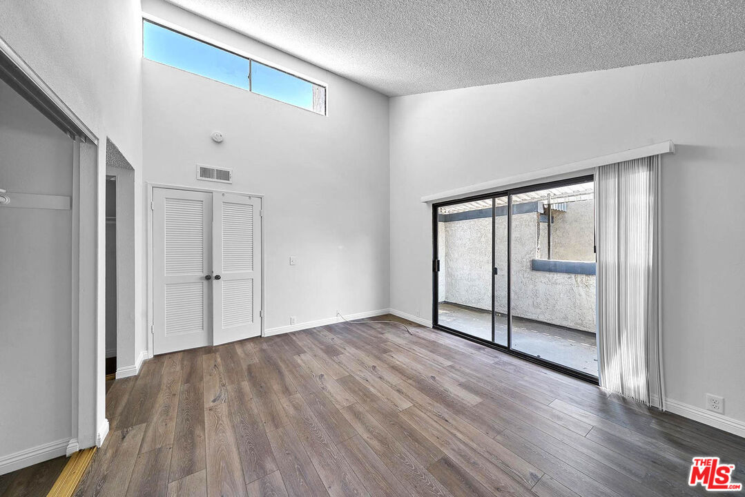 1333 Valley View Road, Unit 25 Glendale, CA 91202 - Photo 21 of 27 a view of empty room with wooden floor and fan