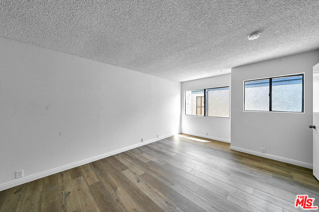 1333 Valley View Road, Unit 25 Glendale, CA 91202 - Photo 24 of 27 a view of an empty room with wooden floor and a window