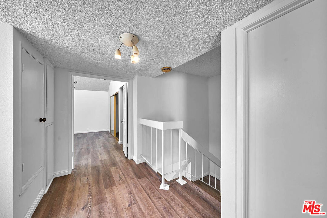 1333 Valley View Road, Unit 25 Glendale, CA 91202 - Photo 25 of 27 a view of a hallway with wooden floor