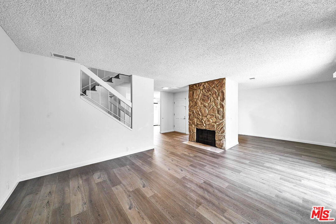 1333 Valley View Road, Unit 25 Glendale, CA 91202 - Photo 4 of 27 a view of a livingroom with wooden floor and fireplace