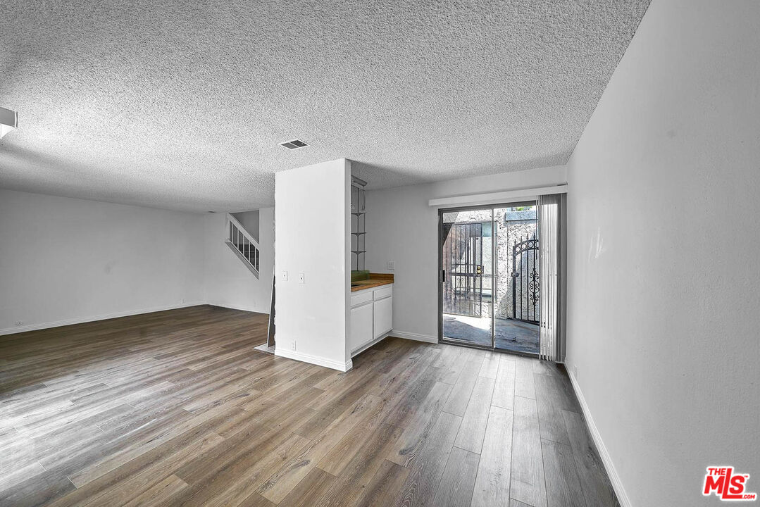 1333 Valley View Road, Unit 25 Glendale, CA 91202 - Photo 7 of 27 a view of an empty room with a window and wooden floor