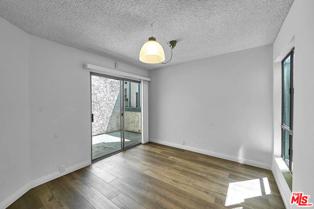 1333 Valley View Road, Unit 25 Glendale, CA 91202 - Photo 10 of 27 an empty room with wooden floor and windows