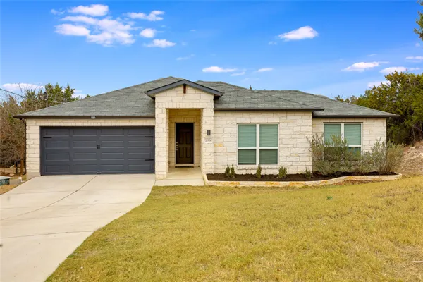 a front view of a house with yard