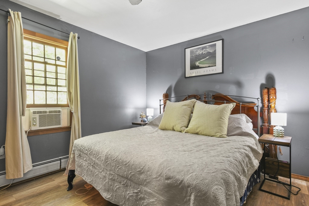 29 Murphy Place Pittsfield, MA 01201 - Photo 15 of 26 a large bed sitting in a bedroom next to a window