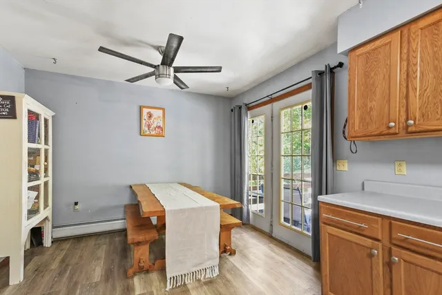 a open kitchen with stainless steel appliances granite countertop a refrigerator a stove top oven a sink and dishwasher with wooden floor