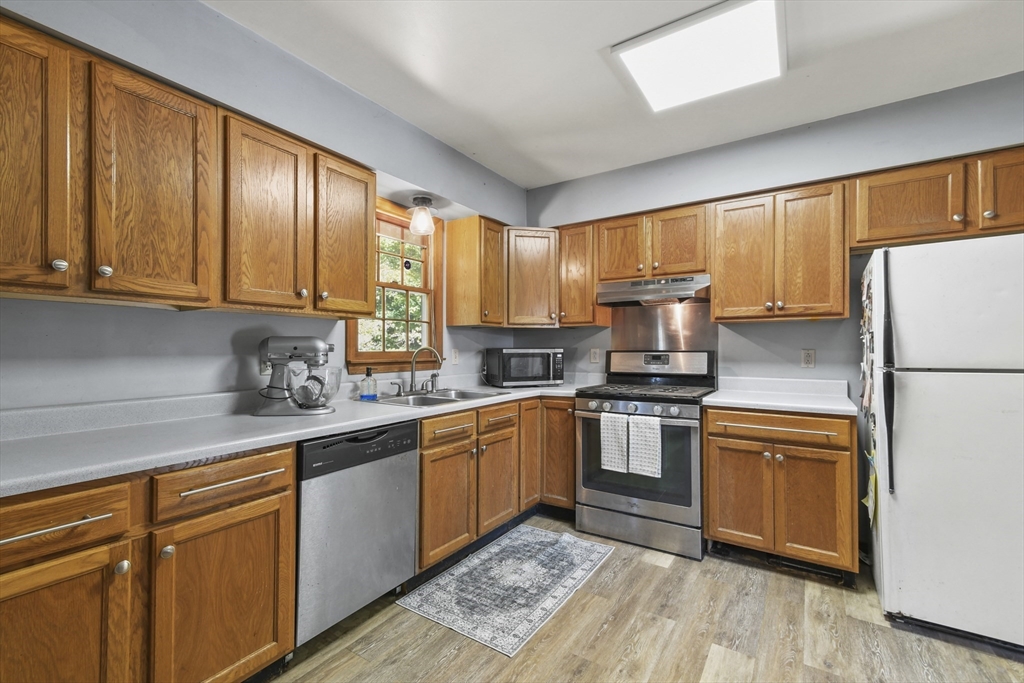 29 Murphy Place Pittsfield, MA 01201 - Photo 8 of 26 a kitchen with granite countertop wooden cabinets stainless steel appliances and a window