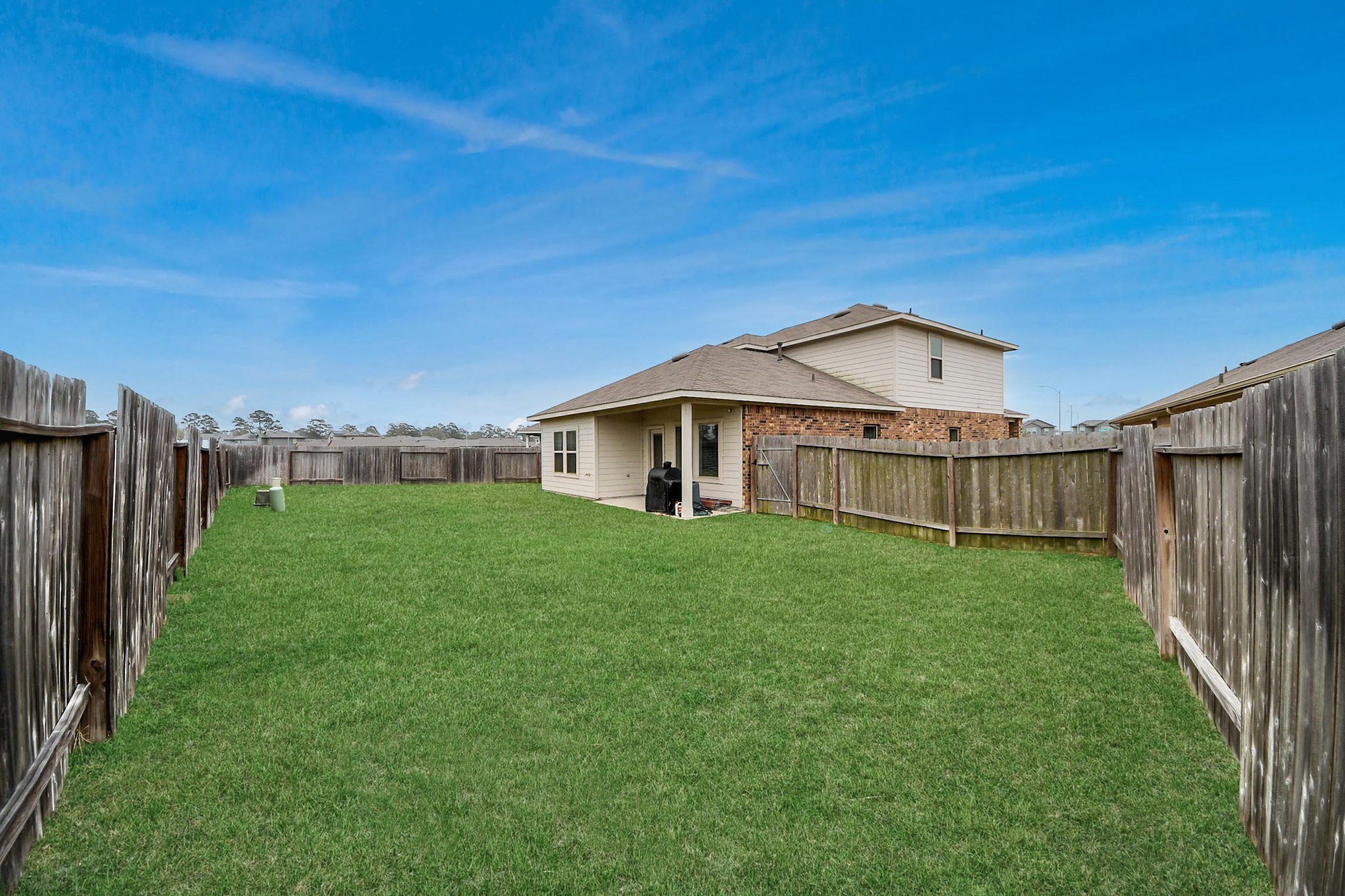 2347 Pettingell Way Spring Spring, TX 77373 - Photo 40 of 41 Backyard view showcasing generous lot size and clear skies.