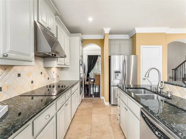 a kitchen with granite countertop cabinets a dining table and a window
