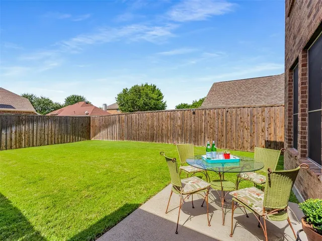 a front view of a house with yard and wooden fence