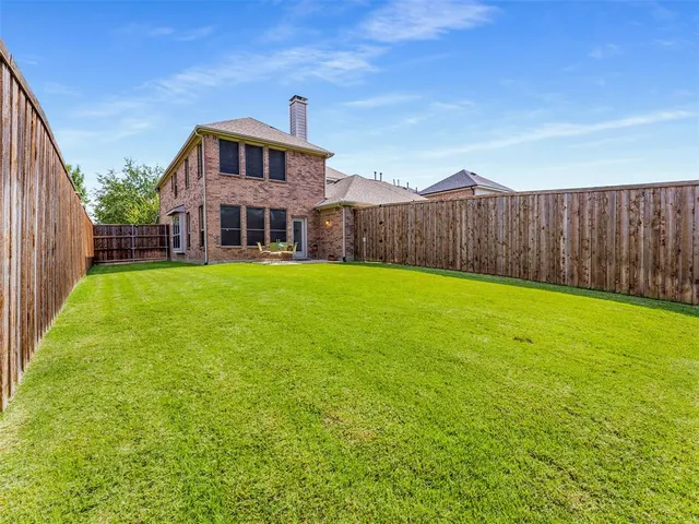 a front view of a house with a garden and yard