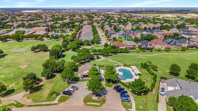 a front view of a house with a garden and yard