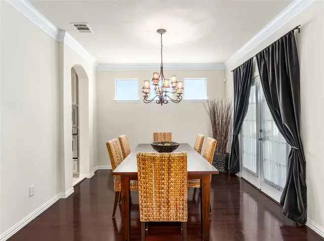 a kitchen with a sink stove and chairs