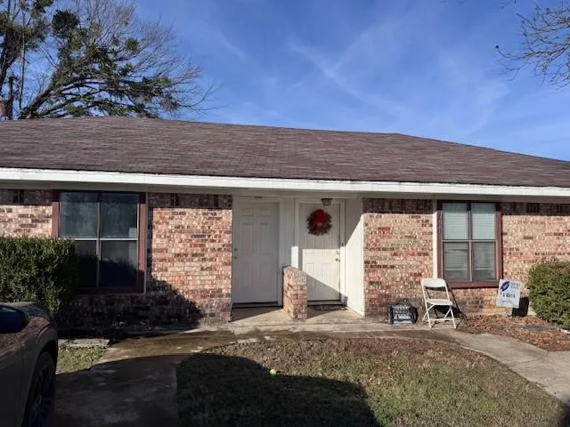 a view of a room with wooden floor and a ceiling fan