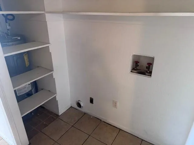 a view of a yard with wooden fence