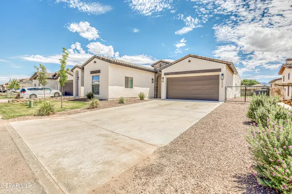 a kitchen with stainless steel appliances granite countertop a stove a sink and white cabinets