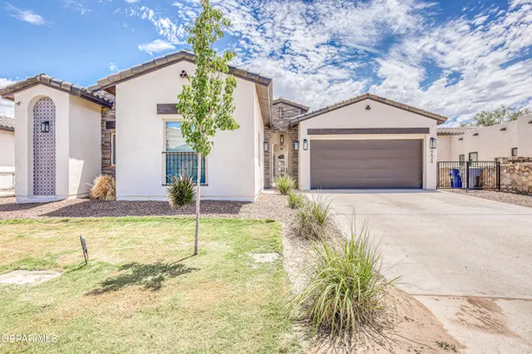 a large white kitchen with lots of counter space and windows