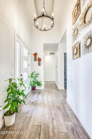 a dining room with furniture wooden floor and a floor to ceiling window