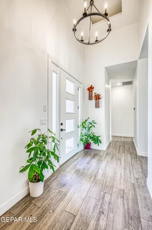 a living room with furniture a fireplace and a floor to ceiling window