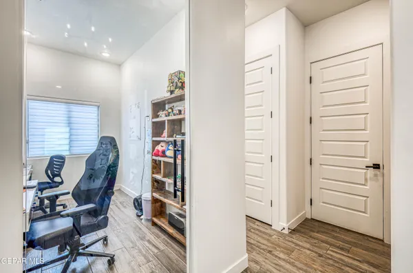 a living room with furniture a flat screen tv and a floor to ceiling window