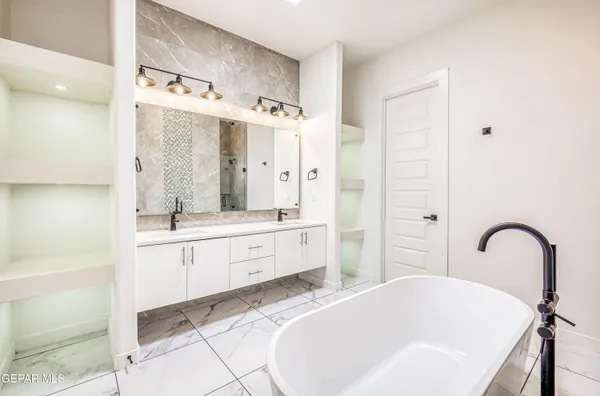 a view of a workspace with furniture and a flat screen tv