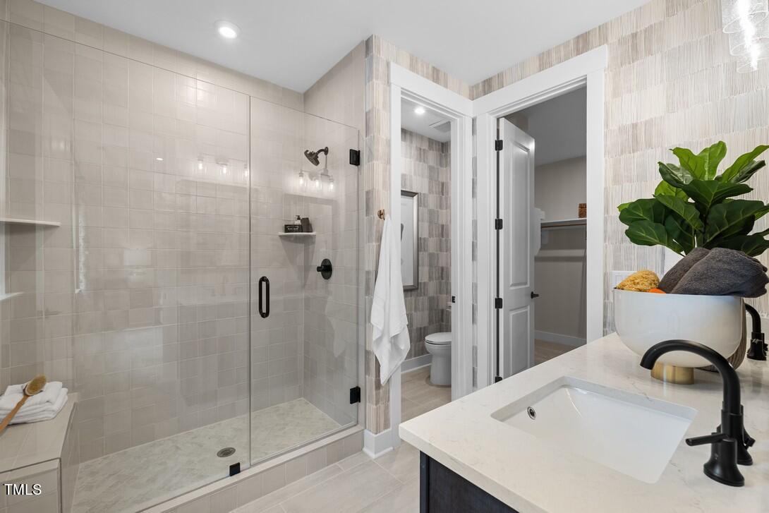 4708 Cypress Tree Lane, Unit 27 Raleigh, NC 27612 - Photo 7 of 9 a bathroom with a sink and a shower