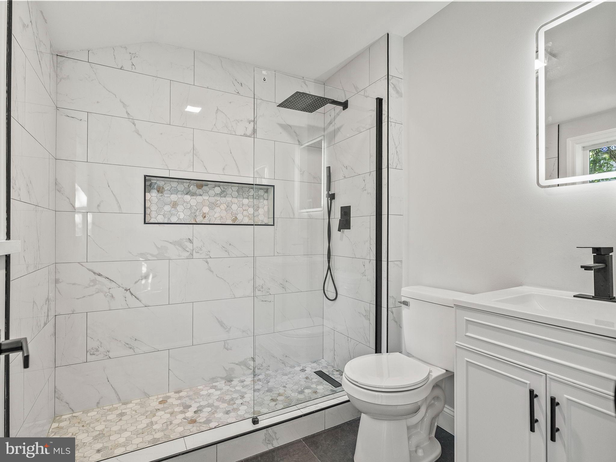 3464 Division Street Philadelphia, PA 19129 - Photo 16 of 40 a bathroom with a sink a toilet and shower