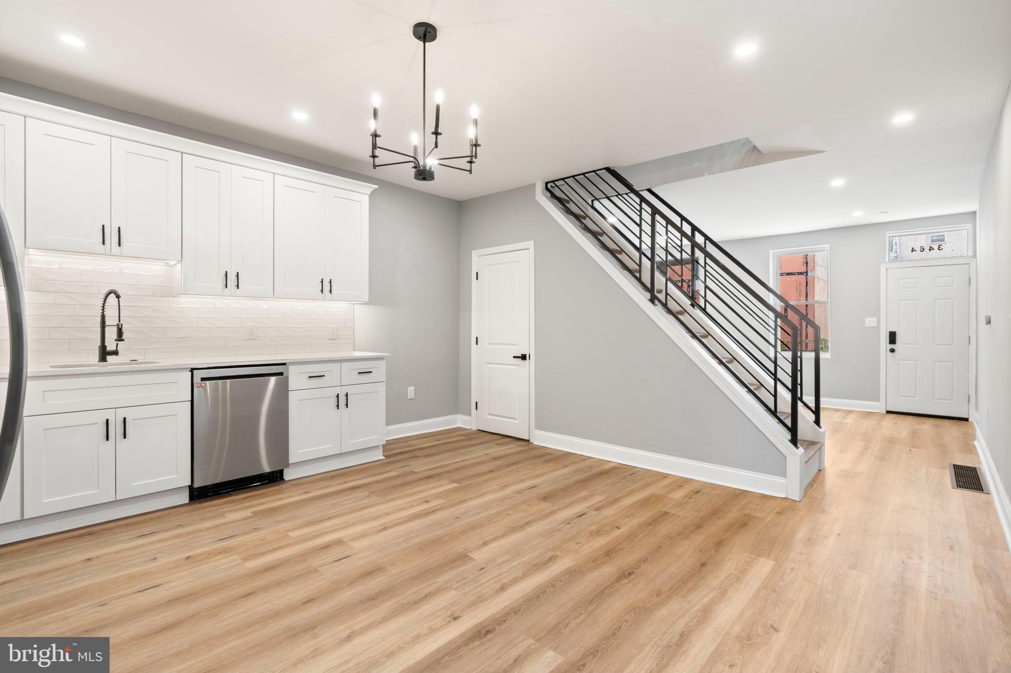 3464 Division Street Philadelphia, PA 19129 - Photo 17 of 40 a view of a kitchen with a sink wooden floor and staircase