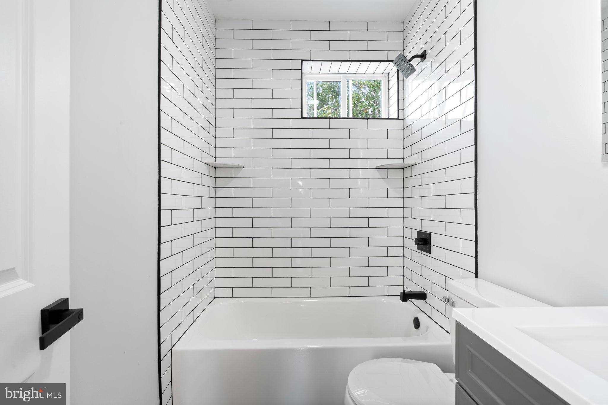 3464 Division Street Philadelphia, PA 19129 - Photo 22 of 40 a bathroom with a bathtub and shower