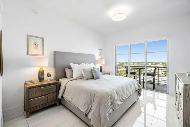 a bedroom with a bed and a large window