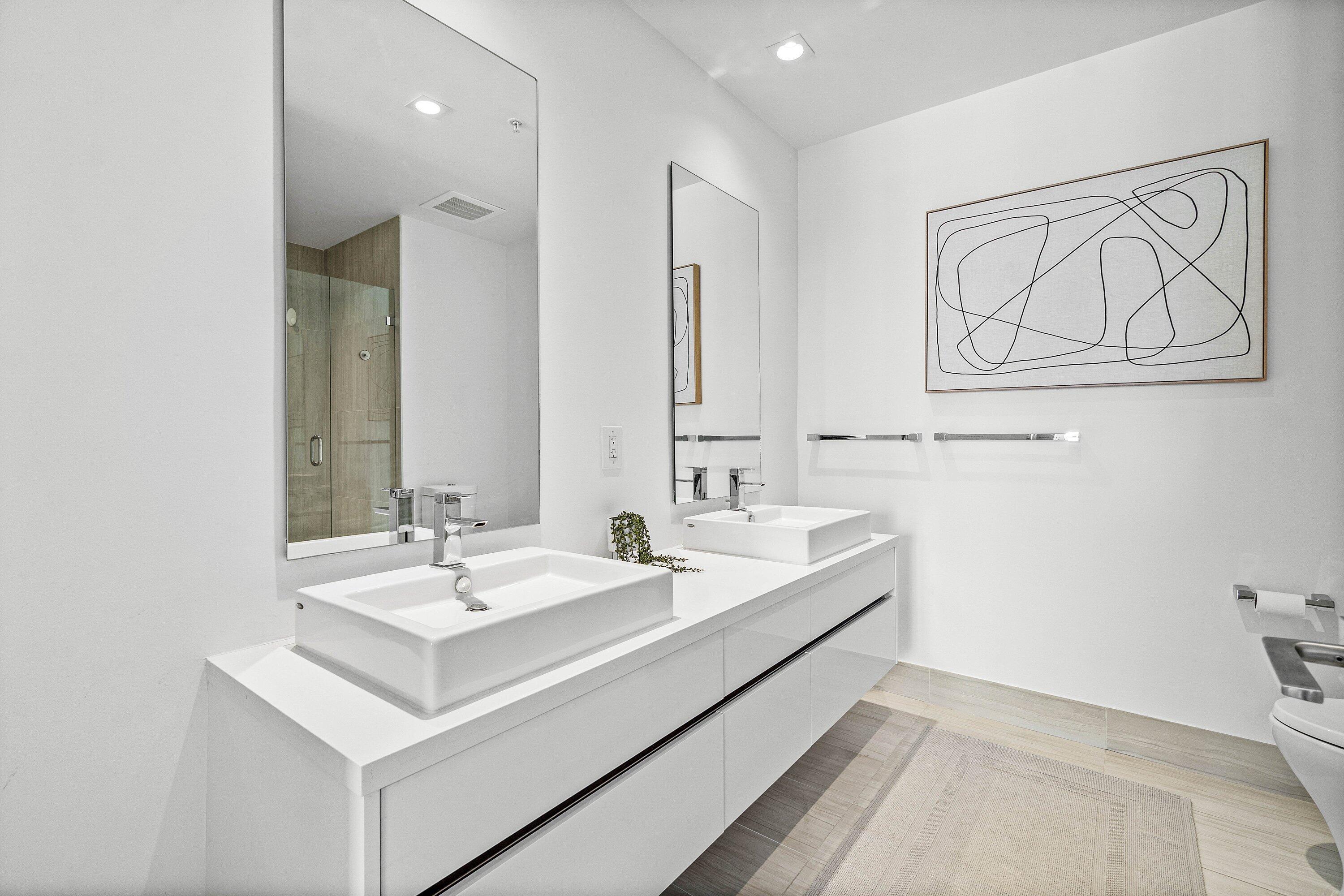 155 East Boca Raton Road, Unit 1119 Boca Raton, FL 33432 - Photo 14 of 42 a bathroom with 2 sink and a mirror