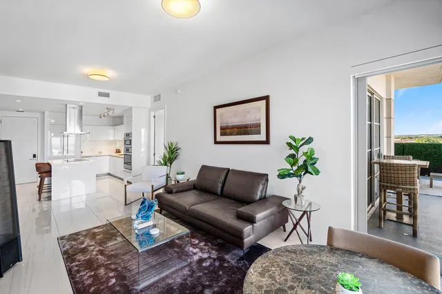 a living room with furniture wooden floor and a potted plant