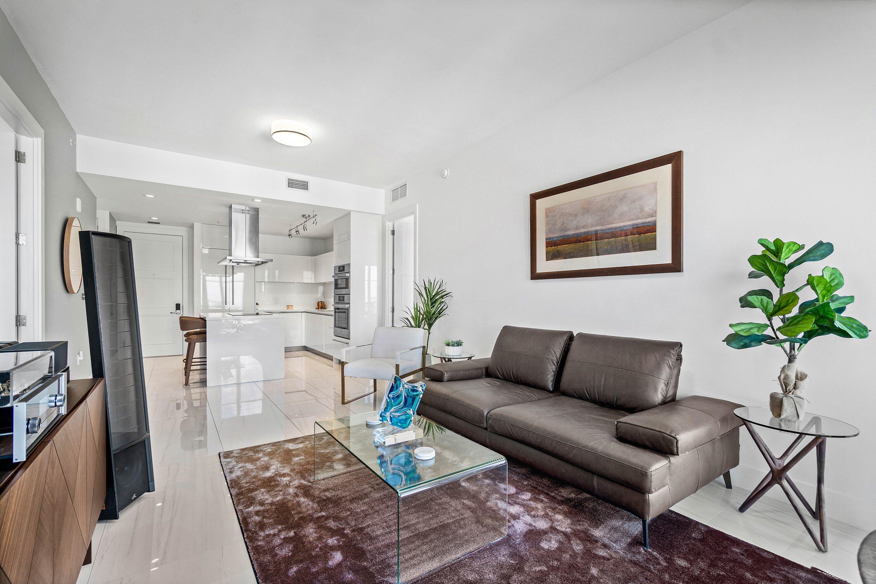 155 East Boca Raton Road, Unit 1119 Boca Raton, FL 33432 - Photo 5 of 42 a living room with furniture potted plant and kitchen view