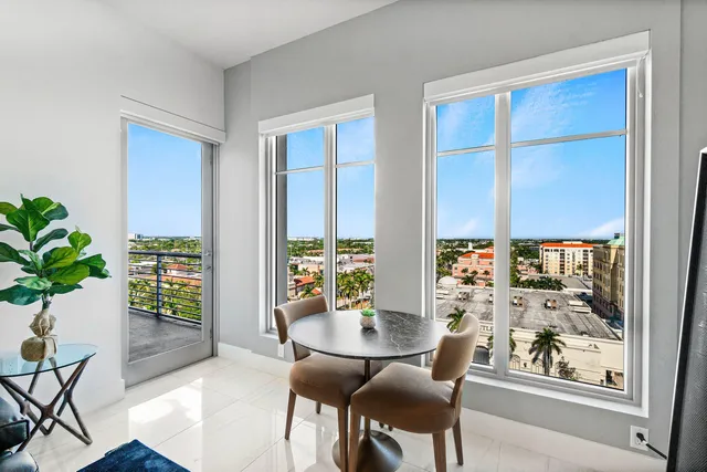 a dining room with furniture and a potted plant