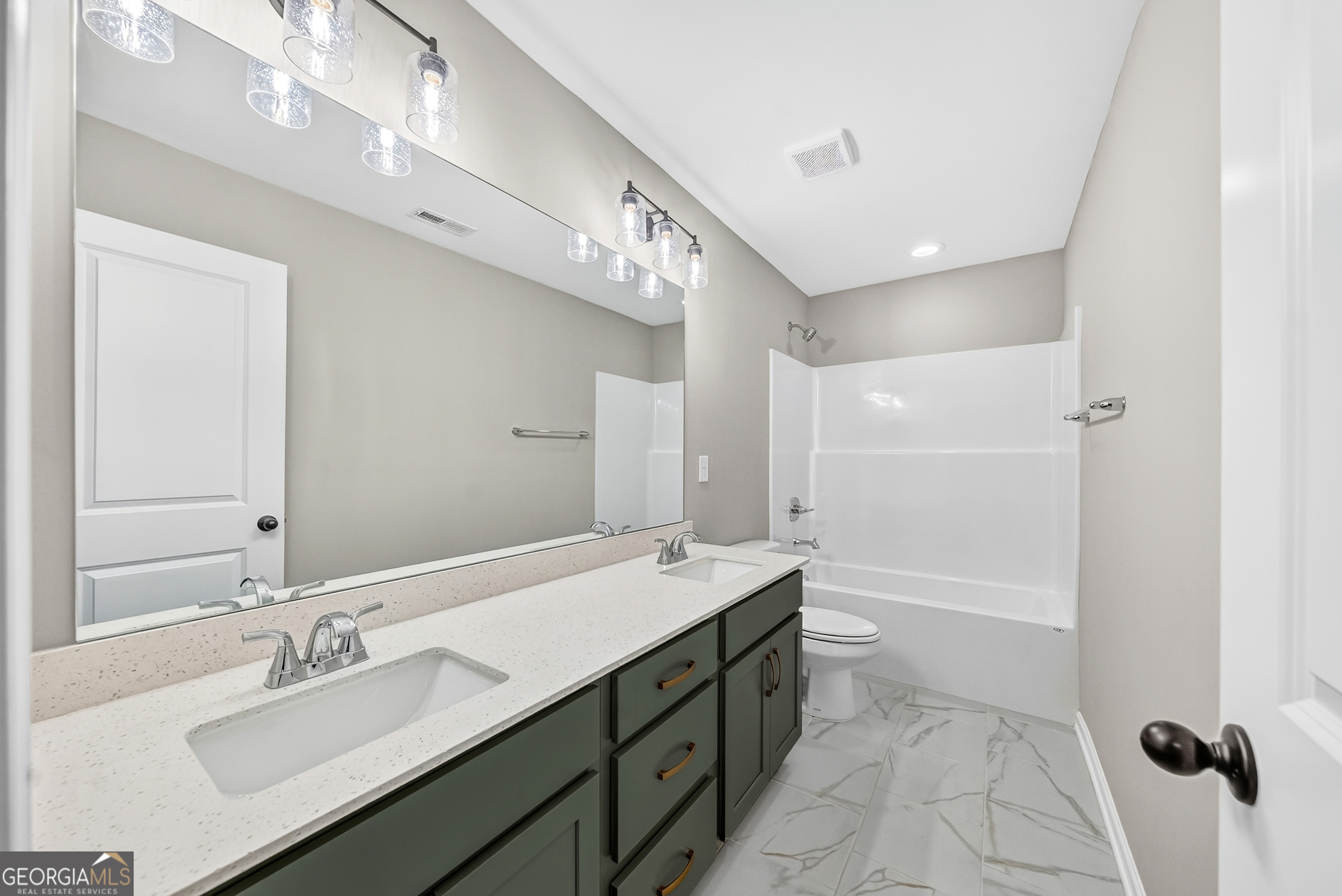 38 Oak Ridge Drive, Unit 26 Waverly Hall, GA 31831 - Photo 27 of 37 a bathroom with a double vanity sink a mirror and a bathtub