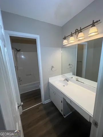 a bathroom with a sink a mirror and a shower