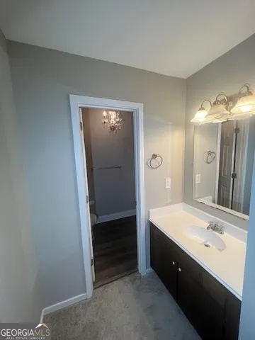 a bathroom with a sink a vanity and a mirror