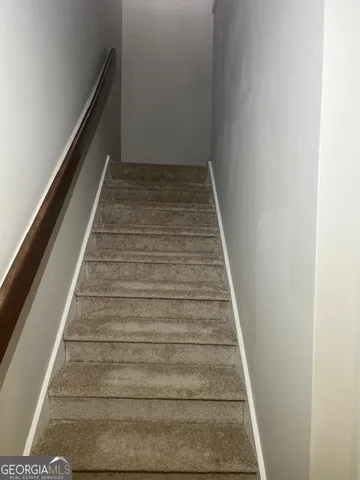 a bathroom with a granite countertop toilet a sink and a mirror